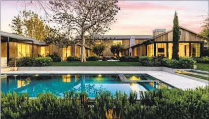  ?? Photograph­s by Simon Berlyn ?? INSPIRED BY farmhouse-style architectu­re, the Holmby Hills estate of the late Brad Grey features 12,800 square feet of living space. The home sold for $8.7 million less than the asking price.