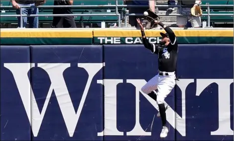  ?? AP Photo/Charles Rex Arbogast ?? Chicago White Sox’s Billy Hamilton makes a leaping catch of Minnesota Twins’ Kyle Garlick’s deep fly ball with the bases loaded during the fourth inning of a baseball game on Thursday in Chicago.