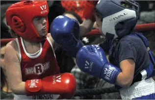  ??  ?? Lloyminste­r's Sydney Collinge ( at left) and Swift Current's Dashanda Fehr-Spence trade punches during their bout.