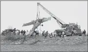  ?? AP/Loveland Reporter-Herald/JENNY SPARKS ?? A crane lifts an airplane that crashed Monday in Culver Reservoir near Berthoud, Colo. Two people who were in the plane were later pronounced dead at a nearby hospital.