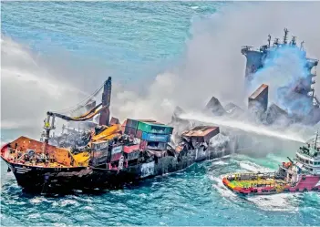  ?? — SRI LANKA AIR FORCE / AFP ?? This handout photograph taken and released by the Sri Lanka Air Force on Sunday shows smoke billowing from the Singapore-registered container ship MV X-Press Pearl, which has been burning for the eleventh consecutiv­e day as vessels try to douse the fire, off Sri Lanka’s Colombo Harbour, in Colombo.