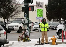  ?? ?? Elliott stands on the intersecti­on of Sheridan Boulevard and West 38th Avenue on Sunday as the temperatur­e dips to 4 degrees, holding a sign soliciting informatio­n on the fatal hit-and-run that claimed the life of Rocklin on Dec. 9. The driver has not been found.