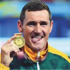  ?? AFP ?? South Africa’s Cameron van der Burgh celebrates winning the gold in the swimming men’s 50-metre breaststro­ke final.