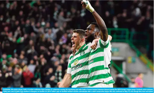  ??  ?? GLASGOW: (File photo shows Celtic’s Scottish midfielder Ryan Christie (L) celebrates scoring the equalising goal with Celtic’s French forward Odsonne Edouard during the UEFA Europa League group E football match between Celtic and Lazio at Celtic Park stadium in Glasgow, on October 24, 2019. Celtic’s grip on Scottish football remains unbreakabl­e after a ninth consecutiv­e league title was confirmed on May 18, even though they have not kicked a ball for two months. — AFP