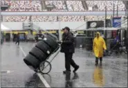  ?? CHUCK BURTON — THE ASSOCIATED PRESS ?? A crew member hauls tires through the NASCAR Xfinity garage at Charlotte Motor Speedway in Charlotte, N.C., Friday, Oct. 7, 2016. Activities at the track were cancelled for the day due to weather.