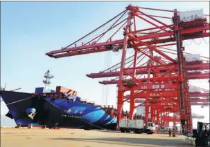  ?? WANG CHUN / FOR CHINA DAILY ?? A cargo vessel is loaded at Lianyungan­g Port, Jiangsu province.