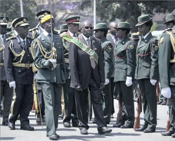  ?? PICTURE: AARON UFUMELI/EPA ?? RULING FOR LIFE? Zimbabwean President Robert Mugabe, centre, inspects a guard of honour mounted for him before the opening of parliament in Harare, Zimbabwe on Tuesday. The flawed electoral process has created a crisis of legitimacy and necessitat­ed a...