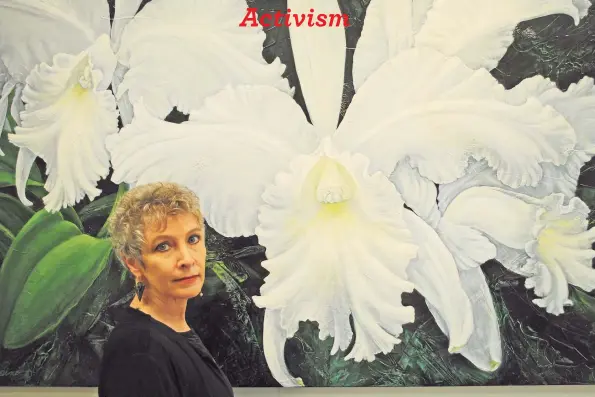  ?? Contribute­d by Patricia Laspino ?? Artist Patricia Laspino in front of her painting “Alice B.” Laspino's work will be on display in the exhibit “Global Garden: Resonant Beauty,” which will be on view in the Stamford Museum’s Bendel Galleries through April 25.