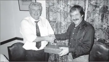  ??  ?? Alf Holliday congratula­tes George McGovern of Whiting Bay on his retirement from the Hydro Electric Board. George, who retired last month, has been with the board for 20 years. 01_B43twe04