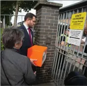  ??  ?? Kirk Moderator and MP Paul Sweeney persuade am officer to accept the petition, left; Springburn Academy pupils Callum Law and Amy Brown, right