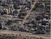  ?? LEO CORREA — THE ASSOCIATED PRESS ?? Destroyed buildings are seen through the window of a U.S. Air Force airplane in the Gaza Strip on Thursday.