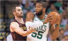  ?? GREG M. COOPER/USA TODAY ?? The Celtics’ Greg Monroe looks to pass against the Cavaliers’ Kevin Love during Game 2 on Tuesday.