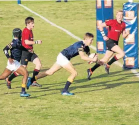  ??  ?? GETTING THROUGH: Graeme College’s Mark Amm crosses for their first try in the schools rugby match against Kingswood at Graeme in Grahamstow­n on Saturday