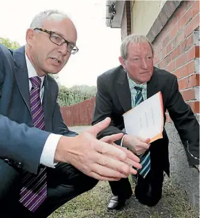  ?? KIRK HARGREAVES ?? Glen Sowry, when he was chief executive of Housing NZ, inspects a state home with Building and Constructi­on Minister Nick Smith.