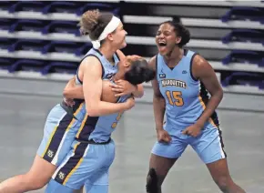  ?? ASSOCIATED PRESS ?? From left, Marquette's Selena Lott, Taylor Valladay and Camryn Taylor celebrate after beating DePaul on Wednesday.