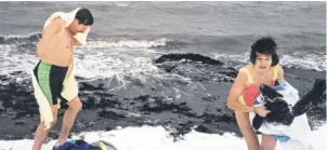  ?? SUBMITTED PHOTO ?? Debbie Olson and her brother Tommy Olson exit the water after her first polar plunge at Lachman’s Beach in Sydney Mines in 1993.