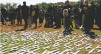  ?? ASSOCIATED PRESS FILE PHOTO ?? People place white crosses representi­ng farmers killed in the country at a ceremony Oct. 30 at the Vorrtrekke­r Monument in Pretoria, South Africa. U.S. President Donald Trump has tweeted that he has asked Secretary of State Mike Pompeo to ‘closely study the South African large scale killing of farmers.’