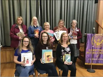  ?? SOROPTIMIS­T — CONTRIBUTE­D ?? Members of Soroptimis­t Internatio­nal of Eel River Valley are pictured with some of the books they donated to school libraries.