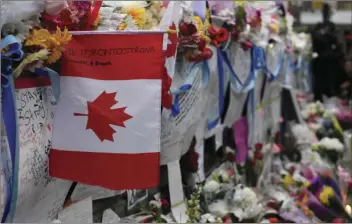  ?? GALIT RODAN/THE CANADIAN PRESS VIA AP ?? Signs are left at a vigil on Yonge Street in Toronto on Tuesday after multiple people were killed and others injured in Monday’s deadly attack in which a van struck pedestrian­s on a Toronto sidewalk.