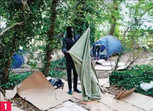  ??  ?? Sheets of cardboard act as beds at the migrant camp near Ouistreham