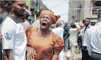  ?? SUNDAY ALAMBA THE ASSOCIATED PRESS ?? A woman cries as a body of child is recovered from the rubble of a collapsed building in Lagos, Nigeria, Wednesday. Rescue effortscon­tinue in Nigeria after a three-storey school building collapsed.
