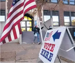  ?? DAVID JOLES/STAR TRIBUNE ?? People leave a Minneapoli­s polling location Tuesday. Voters are deciding whether to replace the city’s police department with a Department of Public Safety.