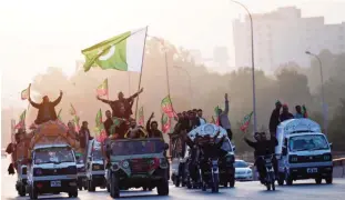  ??  ?? ISLAMABAD: Pakistan Tehreek-e-Insaf (PTI) supporters gesture from vehicles while arriving at zero point as they gather to join a sit-in protest against the government near Parliament in Islamabad yesterday. Opposition leader Imran Khan has announced a...