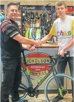  ??  ?? Colin Murray of Nicholson’s Cycles, left, with Ross Duncan, who is undertakin­g a huge charity ride.