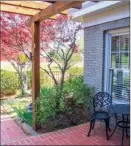  ??  ?? Left: The tiled front porch is covered by a pergola and offers a peaceful spot to relax. Right: Just off the kitchen is a light-  lled space that has a second breakfast bar and built-in storage cabinets.