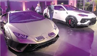  ?? MATIAS J. OCNER mocner@miamiheral­d.com ?? Lamborghin­i shoppers check out a Huracán Sterrato, left, priced at about $270,000, and a Urus, which starts at about $230,000, at the upgraded Davie dealer showroom.
