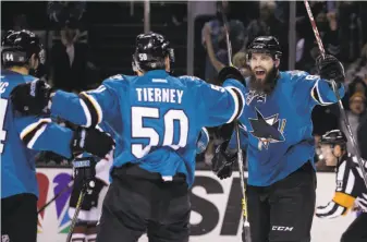  ?? Marcio Jose Sanchez / Associated Press ?? Chris Tierney celebrates with Marc-Edouard Vlasic (left) and Brent Burns after scoring.