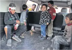  ?? AFP ?? Syrian children sit inside a vehicle as they are evacuated from the scene of a pro-regime forces air strike in Syria’s Idlib province on Tuesday.