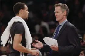  ?? FRANK FRANKLIN II — THE ASSOCIATED PRESS ?? Golden State Warriors coach Steve Kerr, right, talks to Stephen Curry during the first half of Saturday’s game against the New York Knicks at Madison Square Garden in New York. The Warriors won 106-92.