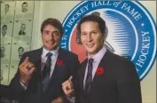  ?? The Canadian Press ?? Teemu Selanne and Paul Kariya pose while showing off their rings as 2017 Hockey Hall of Fame inductees after a press conference in Toronto on Friday.