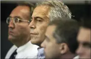  ?? UMA SANGHVI/PALM BEACH POST VIA AP, FILE ?? In this 2008 file photo, Jeffrey Epstein, center, appears in court in West Palm Beach, Fla. The wealthy financier pleaded not guilty in federal court in New York on Monday, to sex traffickin­g charges following his arrest over the weekend. Epstein will have to remain behind bars until his bail hearing on July 15.