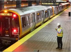  ?? NANCY LANE / BOSTON HERALD ?? A T worker films a test train at Tufts Medical Center T station the day before the Orange Line reopens on Sunday in Boston.