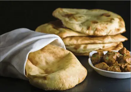  ?? BILL HOGAN/CHICAGO TRIBUNE/MCT ?? Homemade naan can come close to the Indian restaurant staple, and you won’t have to install a tandoori oven.
