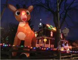  ?? RENÉ JOHNSTON/TORONTO STAR ?? A 20-foot, inflatable Rudolph is the focal point of a massive Christmas display that takes Karin Martin and husband Trevor Walker a month to install each year.