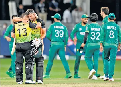  ?? ?? Jubilant embrace: Matthew Wade and Marcus Stoinis celebrate Australia’s five-wicket win over Pakistan in their T20 World Cup semi-final