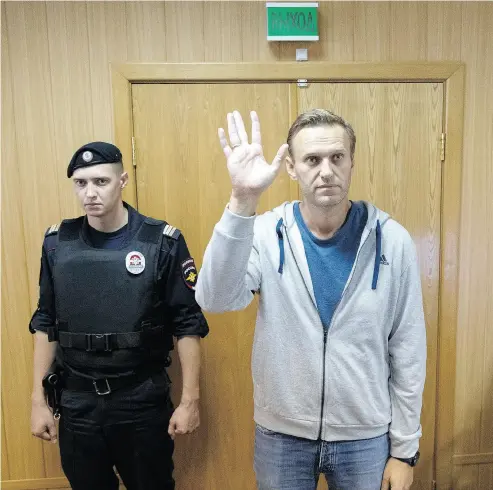  ?? PAVEL GOLOVKIN / THE ASSOCIATED PRESS ?? Russian opposition leader Alexei Navalny in a Moscow courtroom on Monday, when he was sentenced to a month in jail for unsanction­ed protests held in January. This is the second 30-day jail term for Navalny this year.