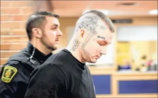  ?? TELEGRAM FILE PHOTO ?? Justin Wiseman, 26, closes his eyes as he passes members of the media on his way into provincial court in a file photo.