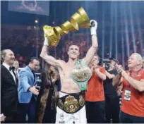  ??  ?? Callum Smith celebrates with the trophy after winning the World Boxing Super Series super-middleweig­ht bout against George Groves in Jeddah on Friday.