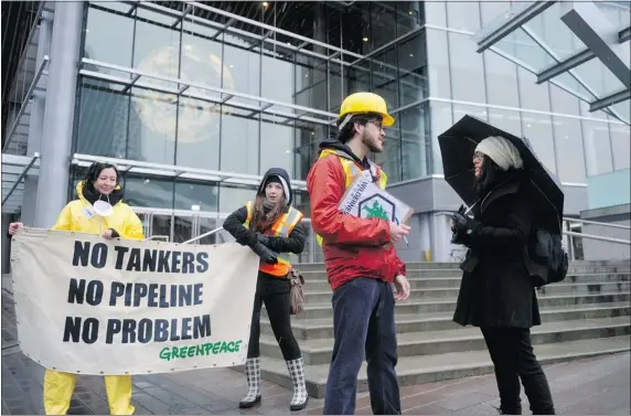  ??  ?? Protestors gather outside the Vancouver Convention Centre Friday to protest increased tanker traffic as Kinder Morgan president Ian Anderson speaks inside.