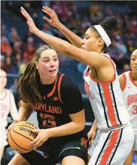  ?? ADAM BETTCHER/GETTY ?? Faith Masonius, left, grabbing a rebound against Ohio State in the Big Ten Tournament on March 8, is one of three Terps to enter the transfer portal.