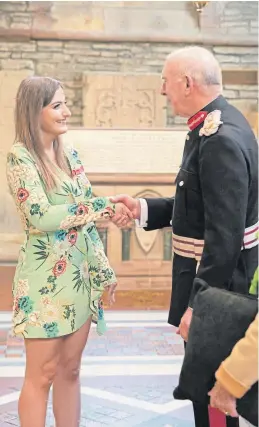  ??  ?? Emily receiving her British Empire Medal from the Lord Lieutenant of Orkney