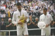  ?? The Associated Press ?? TAKING A STROLL: Serbia’s Novak Djokovic and Switzerlan­d’s Roger Federer walk with the trophies Sunday after the men’s singles final match of the Wimbledon Tennis Championsh­ips in London.