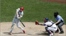  ?? SETH WENIG — THE ASSOCIATED PRESS ?? Philadelph­ia Phillies’ Jay Bruce, left, hits a two-run home run during the sixth inning of a baseball game against the New York Mets at Citi Field, Sunday in New York.