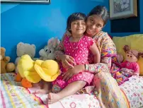  ?? AFP ?? Three-year-old Choity Khatun with her mother Shima in hospital in Melbourne after she had life saving reconstruc­tive surgery. —