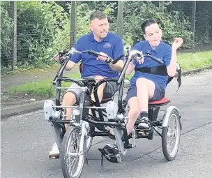  ??  ?? ● Jason Hencher, 14, is cycling 60 miles over six weeks on his adapted bike to raise cash towards Jason’s Wheels Community Trust cycling sessions. He is pictured on the bike with his stepdad Andrew Whitaker