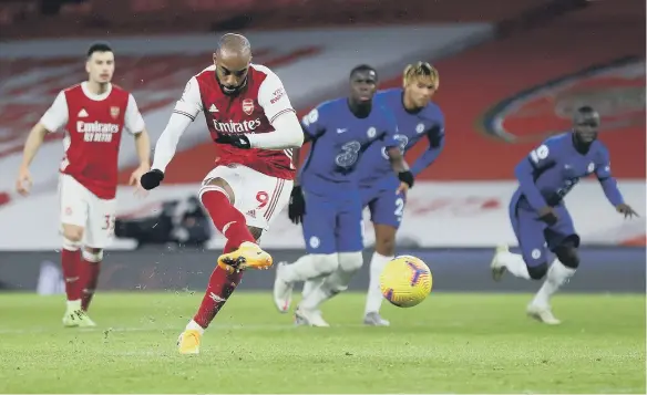  ??  ?? Arsenal’s Alexandre Lacazette scores his side’s first goal of the game against Chelsea.